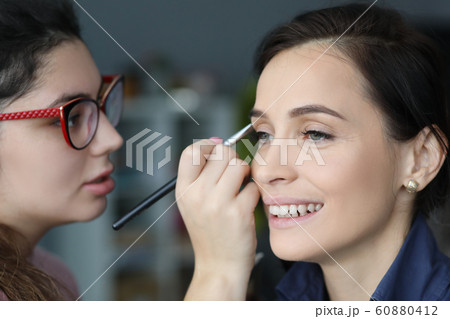 Professional applying paint using brush 60880412