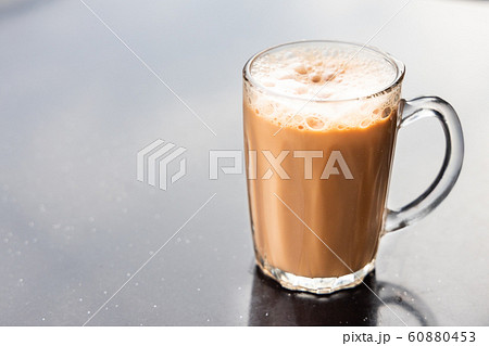Teh tarik, milk tea with froth. Popular drink in Teh tarik, milk tea with froth. Popular drink in 60880453