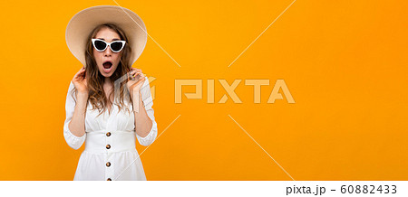 Panorama of beautiful caucasian woman in white suit with big hat and sunglasses smiles isolated on Panorama of beautiful caucasian woman in white suit with big hat and sunglasses smiles isolated on 60882433