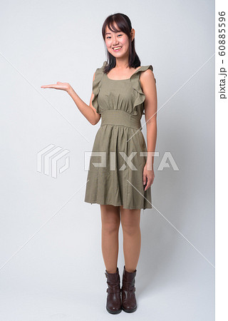 Portrait of beautiful Asian woman against white background Portrait of beautiful Asian woman against white background 60885596