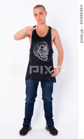 Full body shot of young bald rebellious man pointing at camera Full body shot of young bald rebellious man pointing at camera 60886964