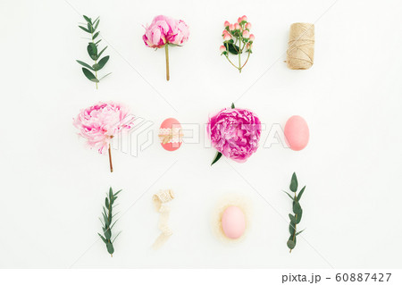 Ester holiday composition with eggs, pink peonies and eucalyptus branches on white background 60887427