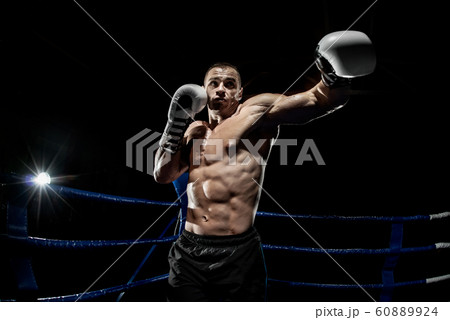 punching boxer on boxing ring punching boxer on boxing ring 60889924