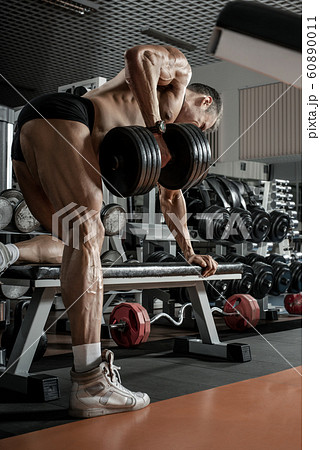 guy bodybuilder with dumbbell 60890011