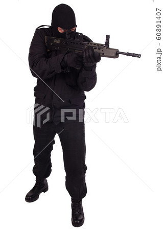 man in black uniform and mask with assault rifle man in black uniform and mask with assault rifle 60891407