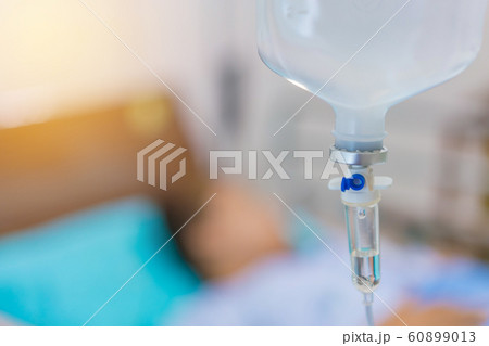 Normal saline solution or sodium chloride with infusion bottle drip for patient in hospital. 60899013