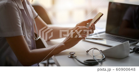Cropped shot of young female doctor using 60900648