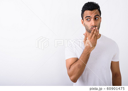 Young handsome Indian man against white background 60901475