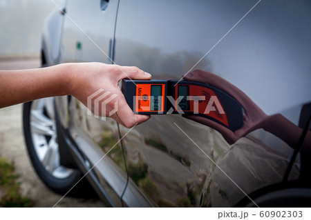 Measuring the thickness of the car paint coating Measuring the thickness of the car paint coating 60902303