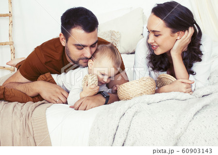 young happy family together having fun in bed, lifestyle people concept 60903143