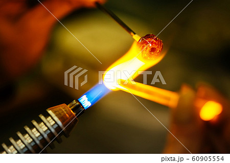 Close-up of glass bead melting in gas-burner fire 60905554