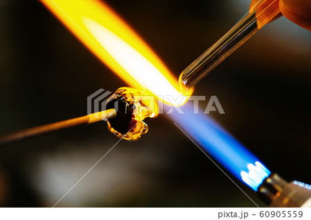 Close-up of glass bead melting in gas-burner fire 60905559