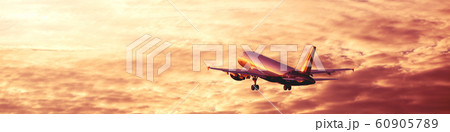 Airplane flying away in awesome cloudy sunset sky Airplane flying away in awesome cloudy sunset sky 60905789