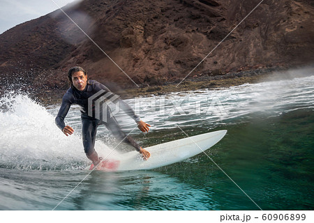 surfer riding waves on the island of fuerteventura surfer riding waves on the island of fuerteventura 60906899