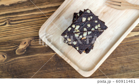 Brownies cake, spoon, and fork on a wooden table. 60911461