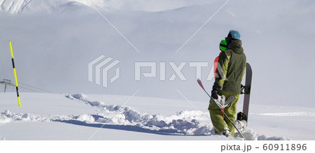 Snowboarders on off-piste slope with new fallen Snowboarders on off-piste slope with new fallen 60911896