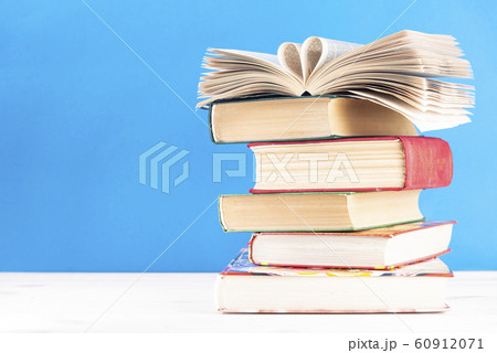 Heart shaped book pages on a stack of old hardback books with text dlch space. Back to school. Education Heart shaped book pages on a stack of old hardback books with text dlch space. Back to school. Education 60912071