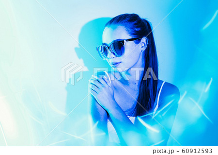 Night image of a woman in blue neon light flashes. 60912593