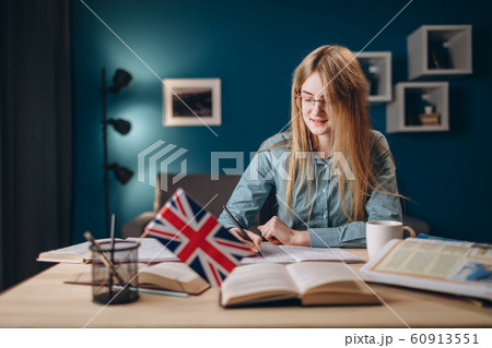 Young Ginger Girl in Glasses Listening to the Text 60913551