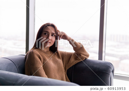 girl sitting in a chair by the window on a winter 60913953