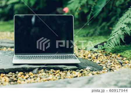 Laptop computer mockup has empty screen outside on 60917344