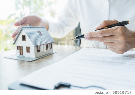 House model with agent asking costumer for contract to buy, get insurance or loan real estate. 60919717