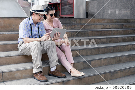 Senior Asian couples sit on stairs, plan, find 60920209