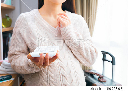 産前産後、入院、出産費用を計算する妊婦 60923024