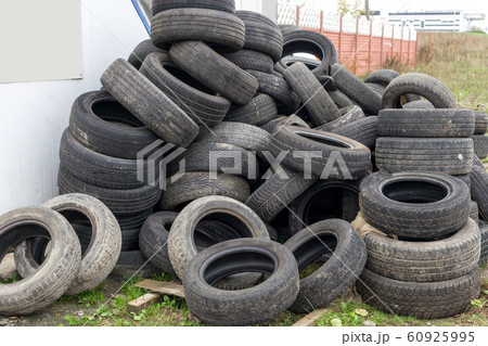 Heap of old used black car tires on junkyard Heap of old used black car tires on junkyard 60925995