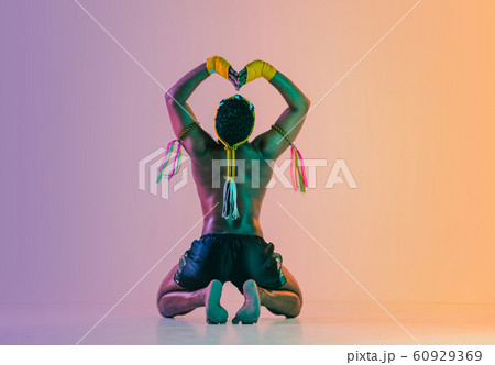Muay thai. Young man exercising thai boxing on gradient background 60929369