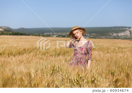 portrait of a beautiful fashionable blonde woman in a hat in a field of ripe wheat portrait of a beautiful fashionable blonde woman in a hat in a field of ripe wheat 60934674