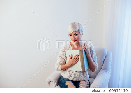 beautiful blonde woman with short book reads book training 60935150