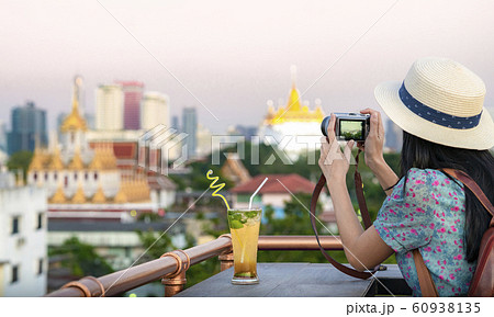 Asian girl  relax on the roof top bar in Bangkok 60938135