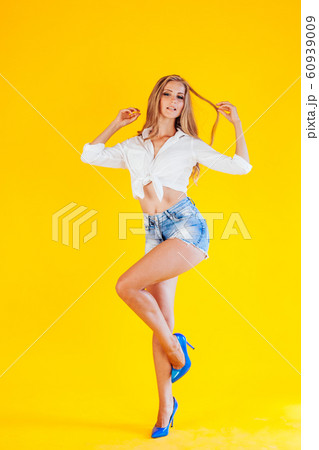 beautiful young girl, blonde on yellow background 60939009