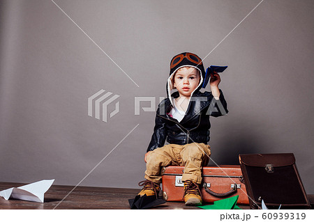 little boy pilot plays in the paper plane 60939319