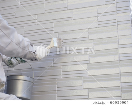戸建て住宅の外壁を塗る塗装職人の手元 60939904