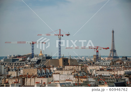 Buildings rooftops with cranes and Eiffel Tower in Paris Buildings rooftops with cranes and Eiffel Tower in Paris 60946762