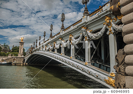 Alexandre III bridge and boats at the Seine River in Paris 60946995