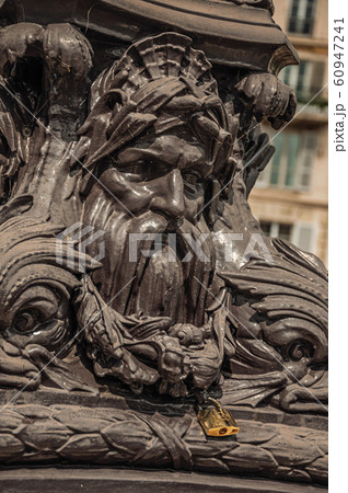 Padlock stuck in frowning iron pole ornament in Paris 60947241