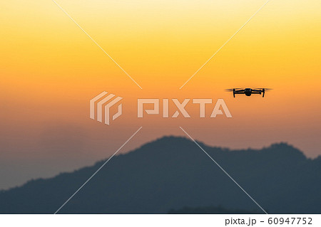 Drone flying in sunset on hilltop 60947752