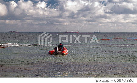A red rubber coast guard rescue boat with a 60947836