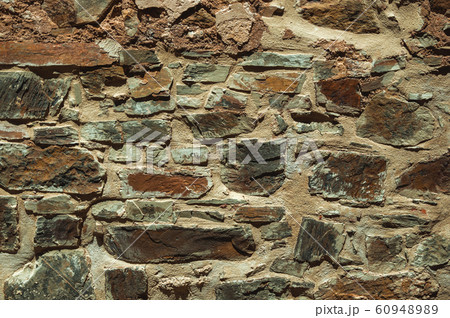 Old wall made of rough stones 60948989