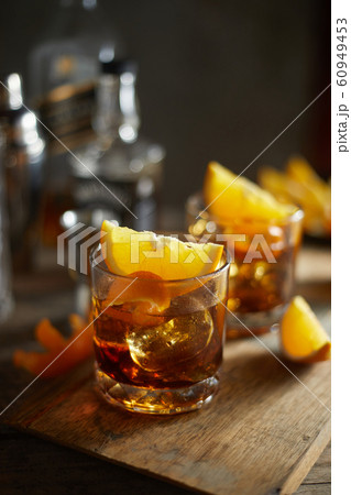 Tasty alcoholic old fashioned cocktail with orange Tasty alcoholic old fashioned cocktail with orange 60949453