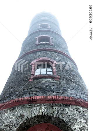A lookout tower in the clouds. The stone tower is A lookout tower in the clouds. The stone tower is 60950166