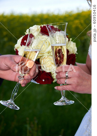 clink glasses by bride and groom clink glasses by bride and groom 60950416