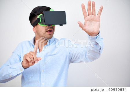 Excited businessman in VR headset Excited businessman in VR headset 60950654