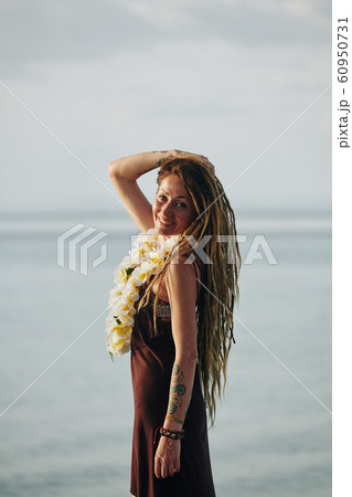 Pretty woman with flower necklace 60950731