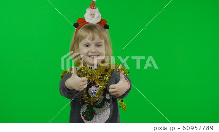 Happy beautiful little girl in a sweater with a snowman. Christmas. Chroma Key Happy beautiful little girl in a sweater with a snowman. Christmas. Chroma Key 60952789