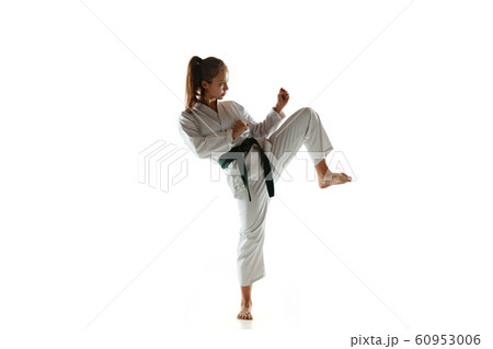Confident junior in kimono practicing hand-to-hand combat, martial arts 60953006