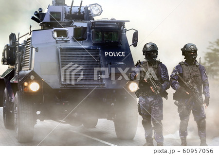 Police special force on standby infront of the armored vehicles during special opps 60957056